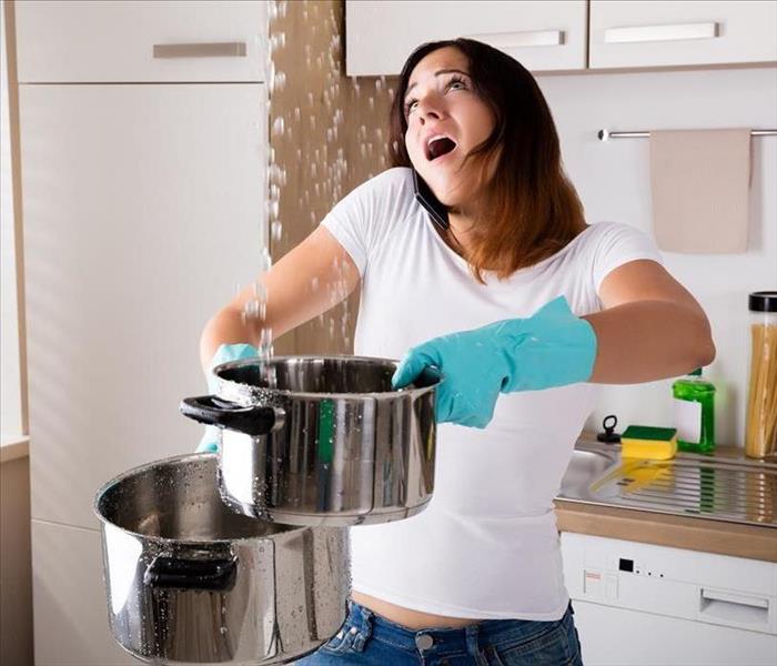 Woman Holding Pot Catching Dripping Water